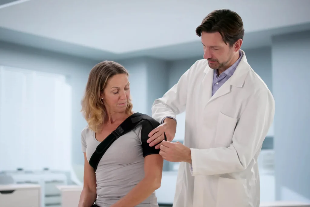 woman outpatient with male shoulder surgeon discussing if shoulder replacement surgery should be performed.