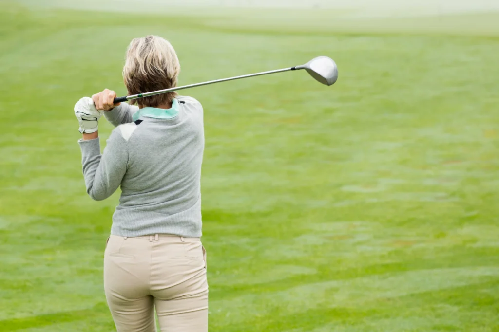 patient playing golf with golfer's elbow.