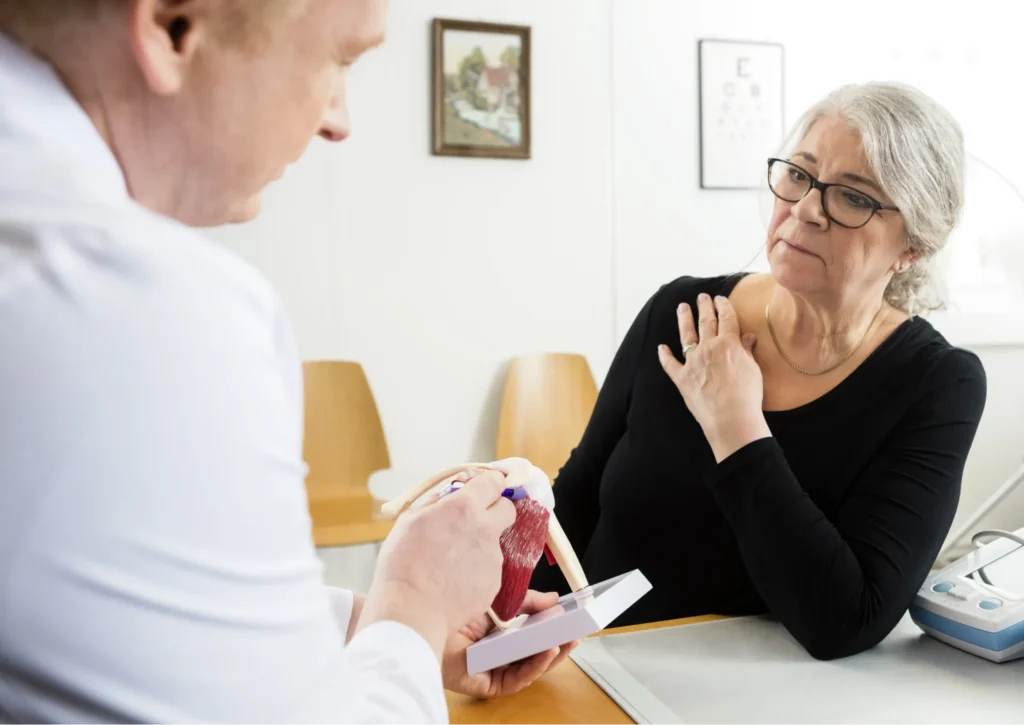 patient discussing shoulder bursitis with her surgeon