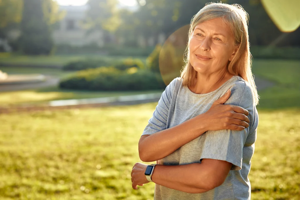 Someone holding shoulder after surgery.